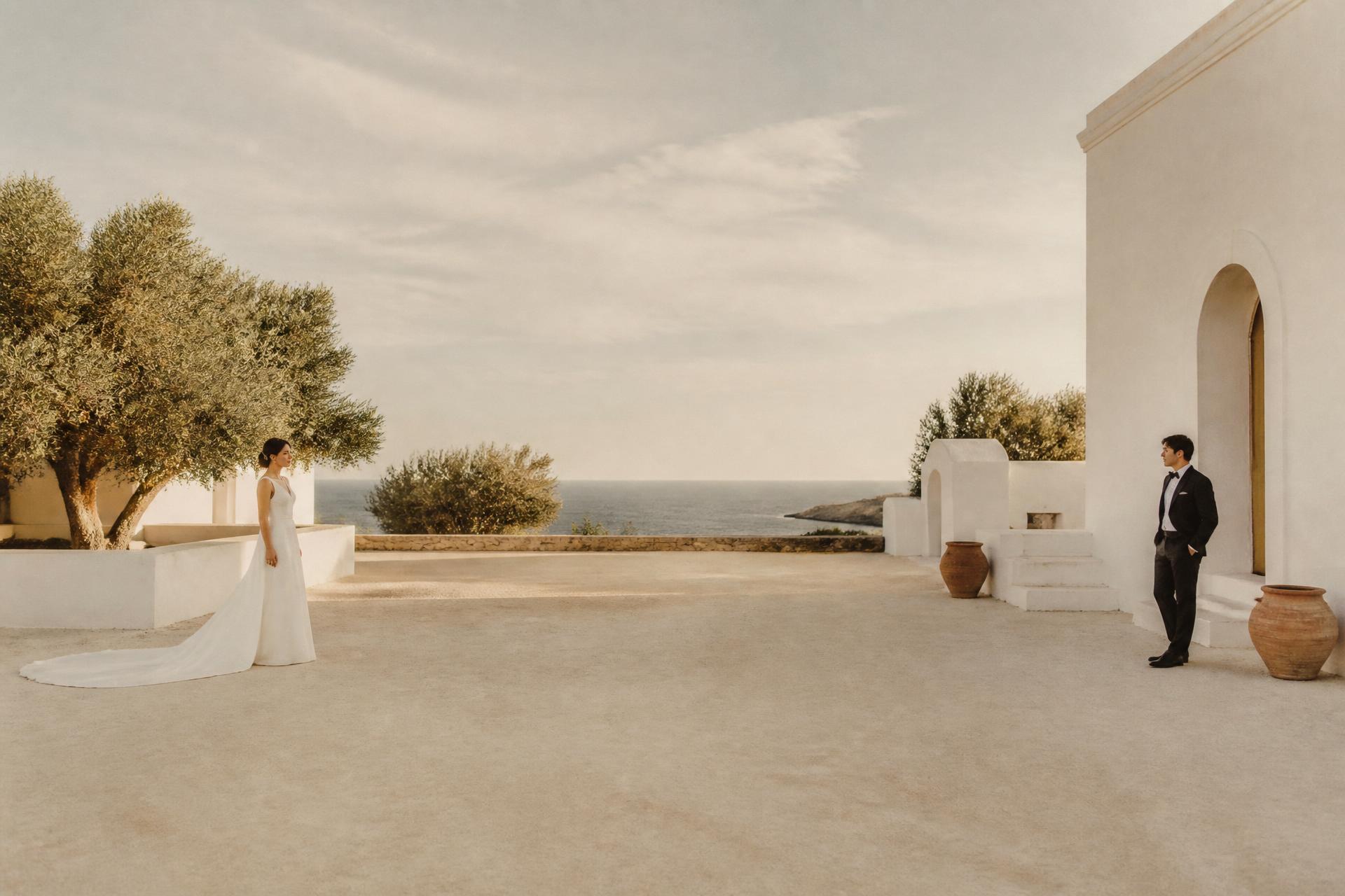 Sunlit stone courtyard set for a Mediterranean wedding reception